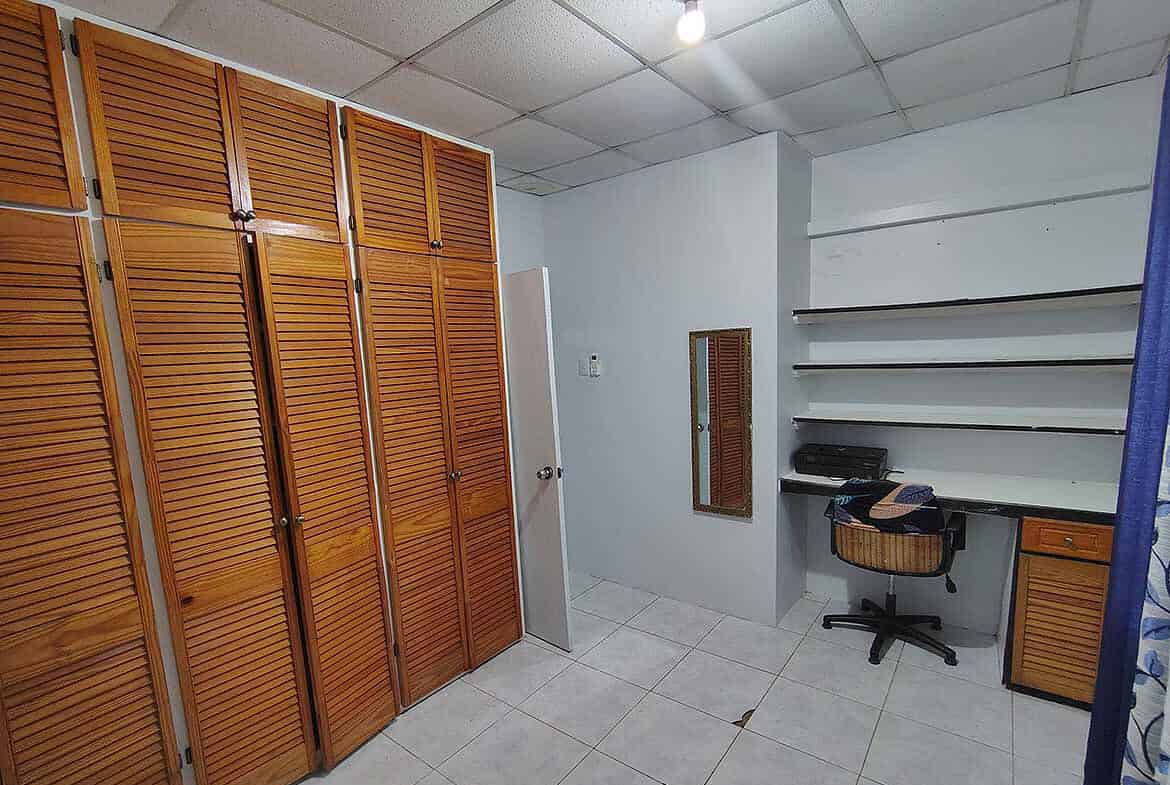 Cornerstone- Interior of storage room with wooden cabinets and shelves at Cashew Gardens.