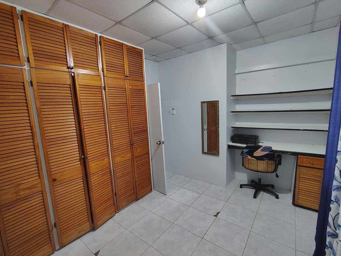 Storage Room at Cashew Gardens Cornerstone- Interior of storage room with wooden cabinets and shelves at Cashew Gardens.
