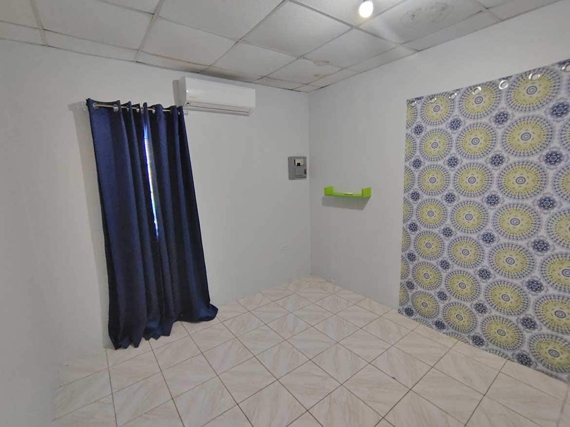 Cornerstone™ Room at Cashew Gardens Cornerstone- Interior room at Cashew Gardens with curtains and patterned wall.