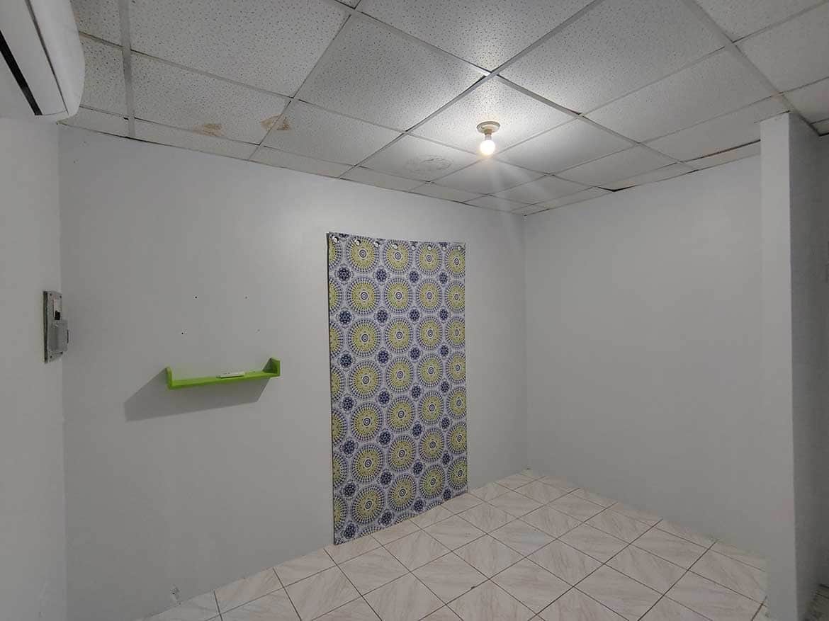 Interior of Cashew Gardens, Edinburgh Cornerstone- Empty room at Cashew Gardens in Edinburgh with patterned wall panel.