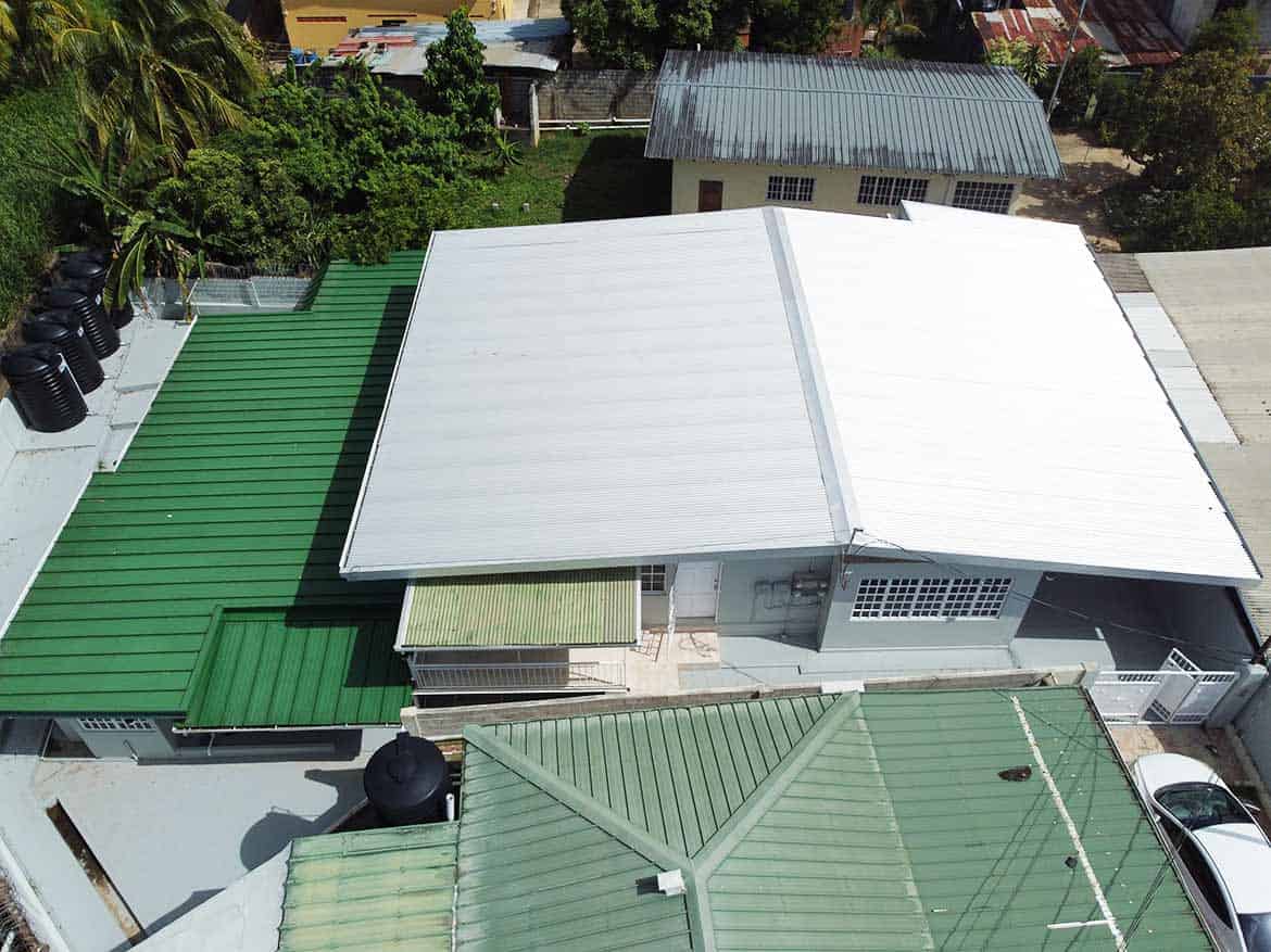 Cornerstone™ Apartment Building Roofs Cornerstone- Aerial view of apartment building roofs with green and white metal roofing.
