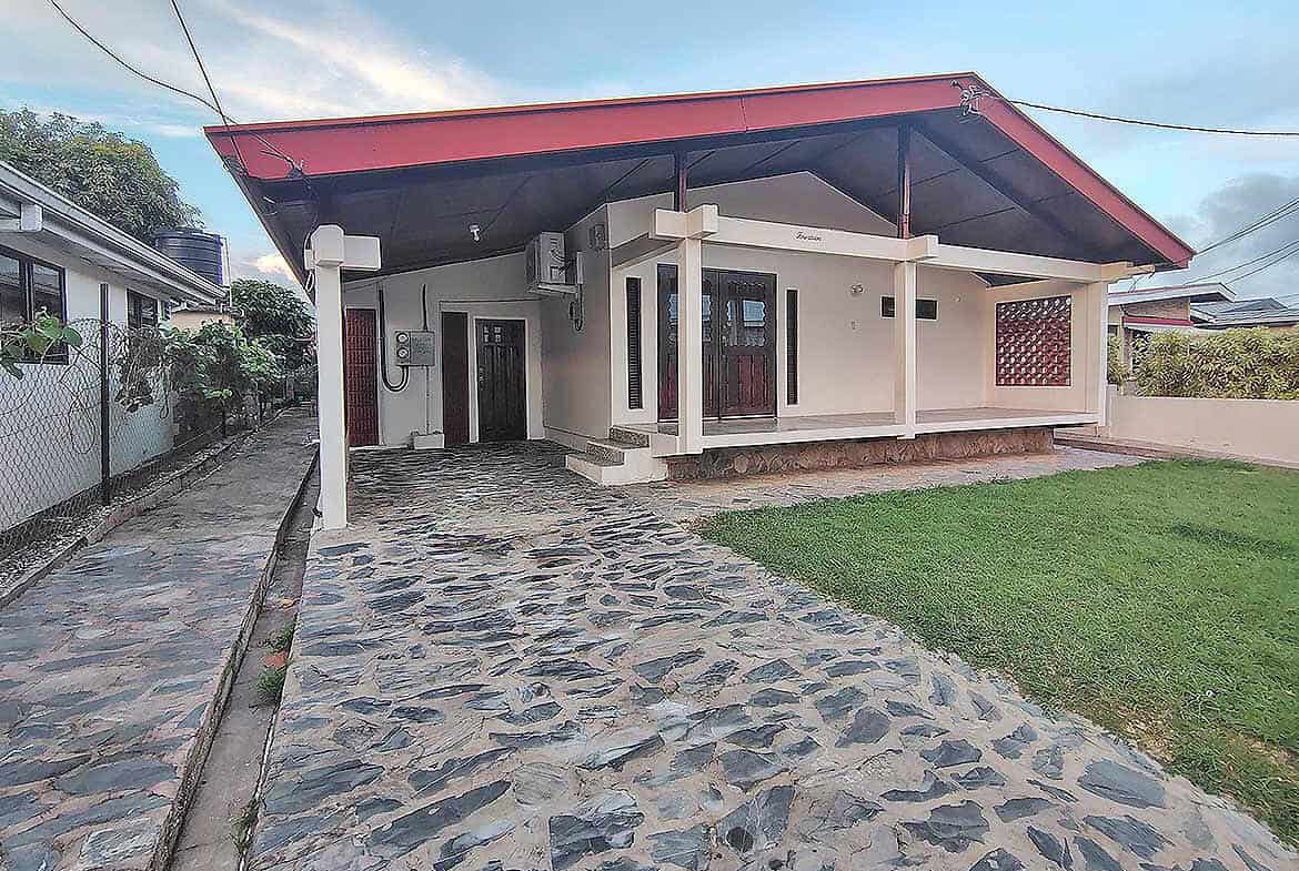Cornerstone- Modern 3-bedroom home with stone driveway and covered porch.