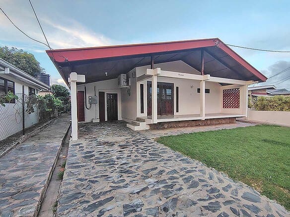 Cornerstone- Modern 3-bedroom home with stone driveway and covered porch.
