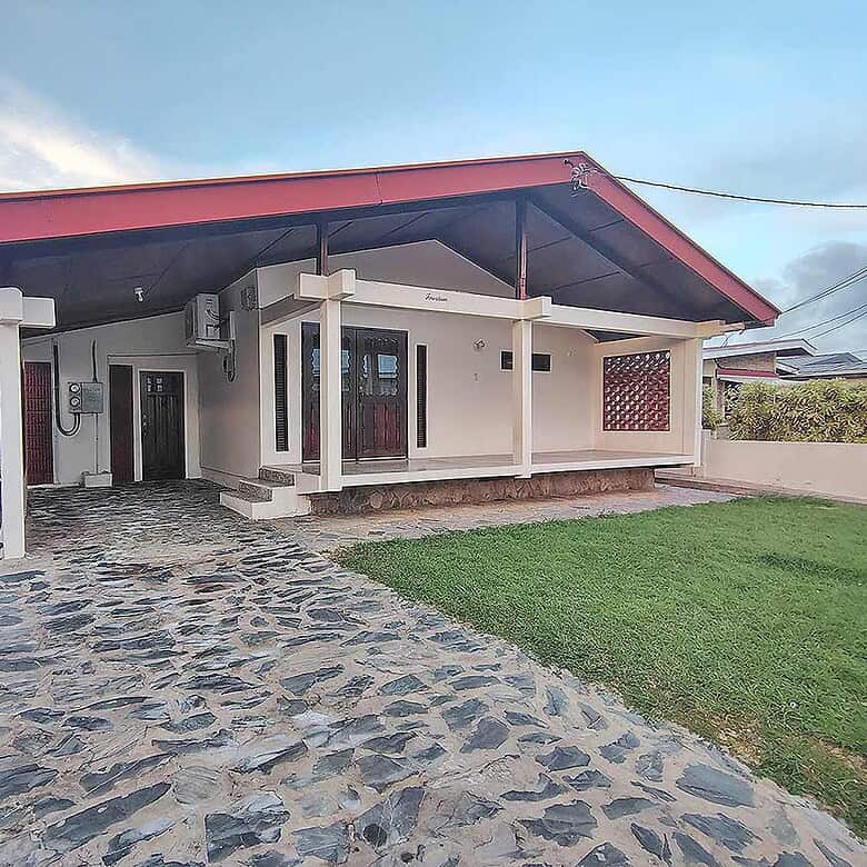 Cornerstone- Modern 3-bedroom home with stone driveway and covered porch.