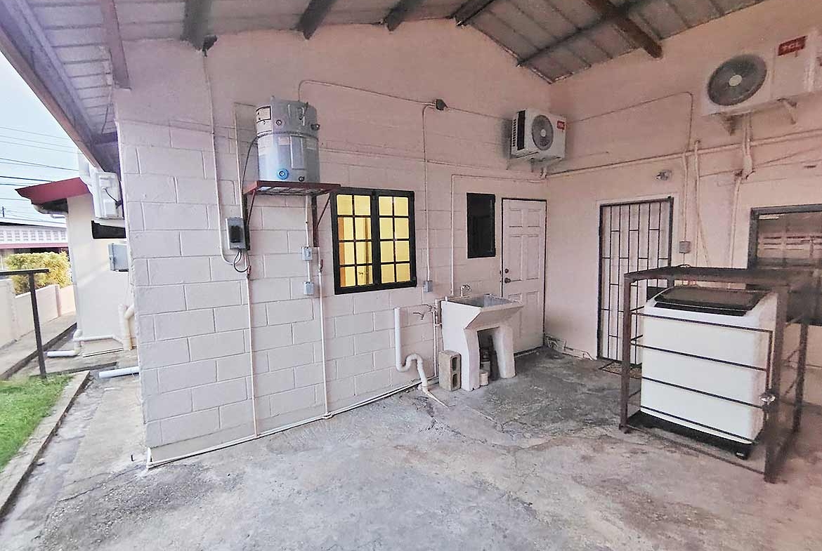 Cornerstone- Laundry space with washing machine, sink, and ventilation fans in Dinsley Gardens home.