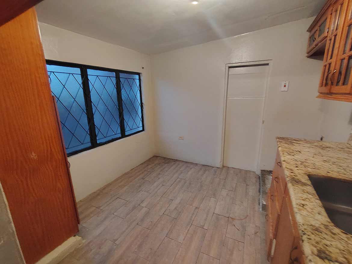 Interior of 3-Bedroom Home in Dinsley Gardens Cornerstone- Spacious kitchen with window view in Dinsley Gardens home.
