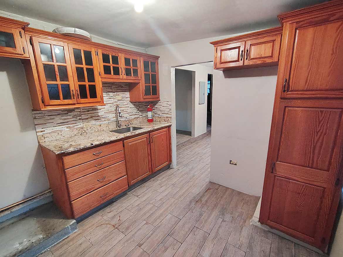 Kitchen of 3-Bedroom Home in Dinsley Gdns Cornerstone- Spacious kitchen with wooden cabinets and granite countertops in Dinsley Gdns home.