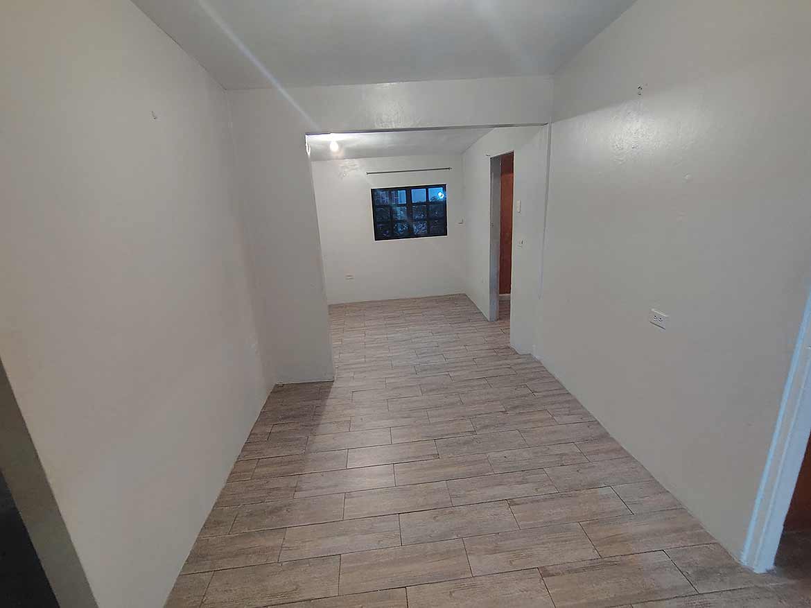 Interior of 3-Bedroom Home in Dinsley Gdns Cornerstone- Spacious living area with wooden flooring and window in Dinsley Gdns home.