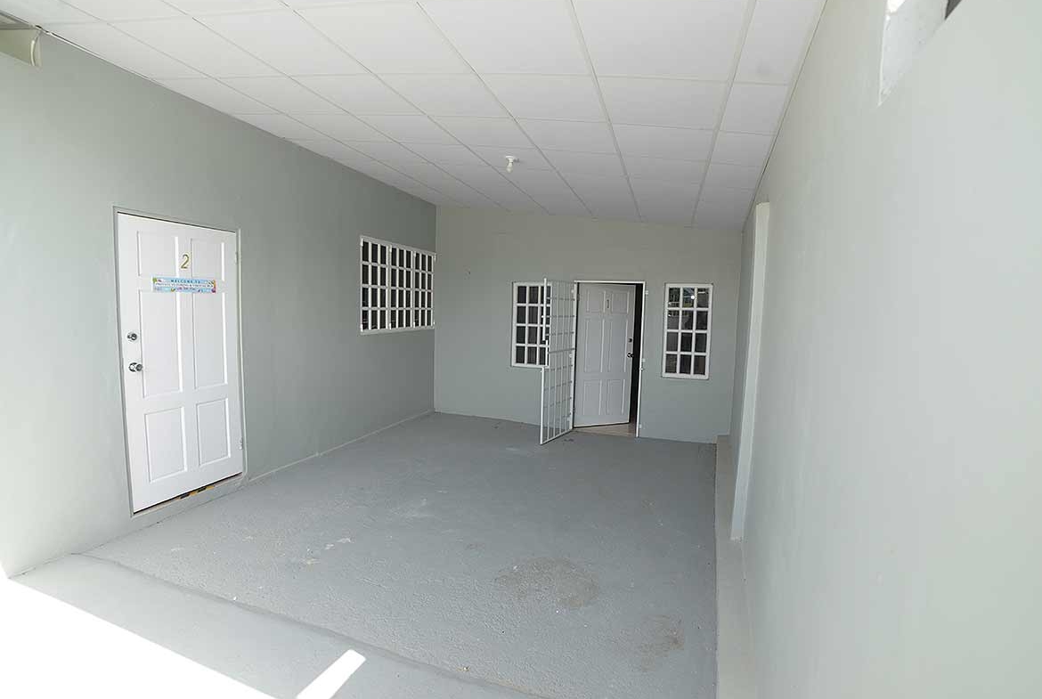 Cornerstone- Empty apartment corridor with white walls and multiple windows at Five Rivers.