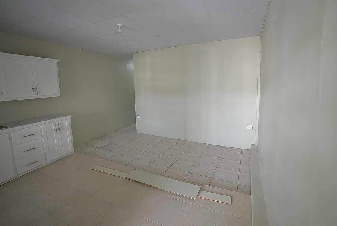 Cornerstone- Empty room in Apartment Building Five Rivers with kitchen cabinets.