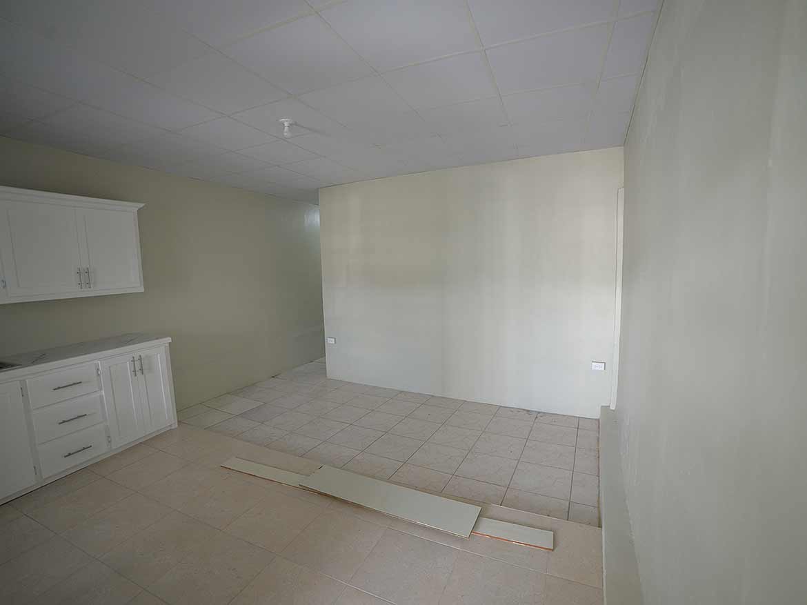 Interior of Apartment Building Five Rivers Cornerstone- Empty room in Apartment Building Five Rivers with kitchen cabinets.
