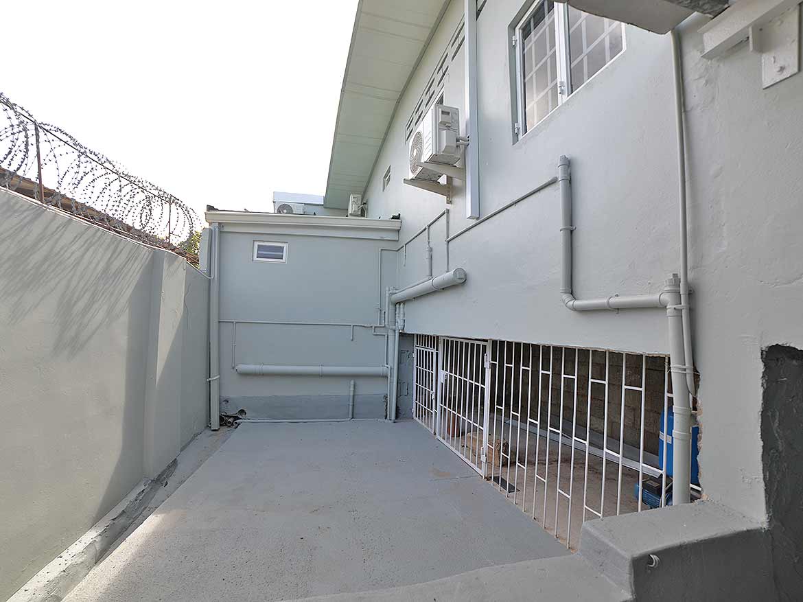 Cornerstone™ Apartment Building Exterior Cornerstone- Exterior view of Cornerstone™ apartment building with security fencing and air conditioning units.