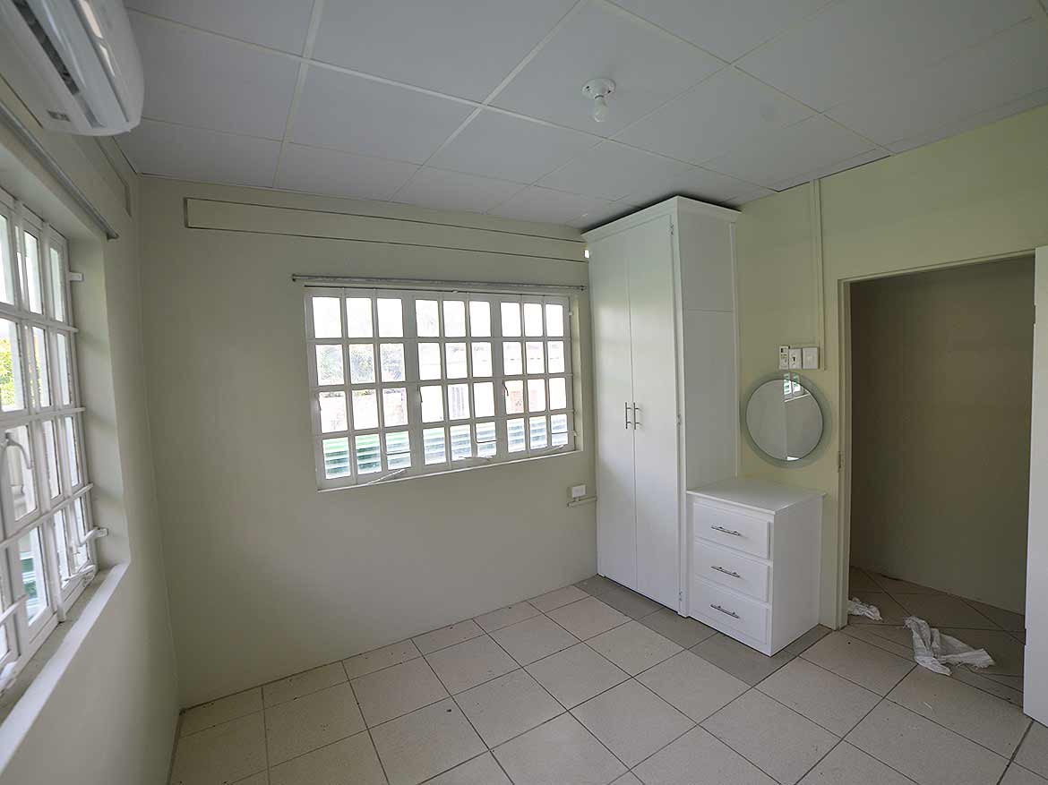 Interior of an apartment room at Five Rivers Cornerstone- Empty apartment room with windows, wardrobe, and dresser at Five Rivers.
